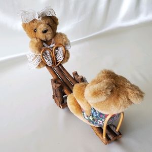 Mama and Papa Bear Playing on a Wooden Seesaw